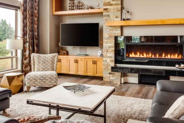 Small living room layout with TV on perpendicular wall and fireplace as primary anchor, warm ivory tones, floating sofa, terracotta rug