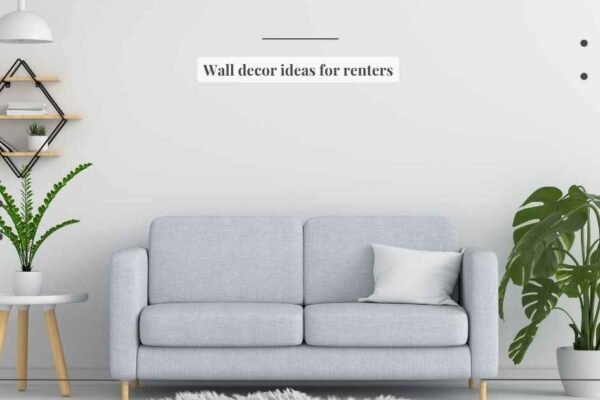 Wall decor ideas for renters featuring leaned canvas art, adhesive-hung frames, and a large floor mirror in a warm neutral apartment